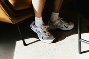 A person sitting in a chair with their legs crossed