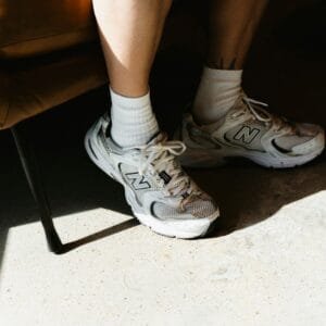 A person sitting in a chair with their legs crossed