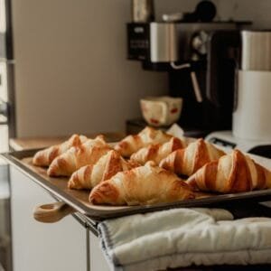 A tray of croissants sitting on top of a counter