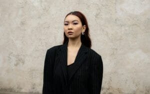 A woman standing in front of a wall