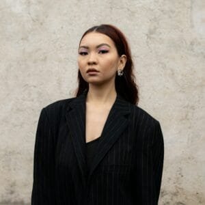 A woman standing in front of a wall