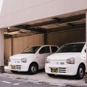 Two white cars parked in a parking garage