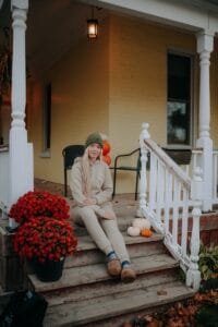 A woman sitting on the steps of a house