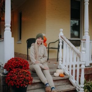 A woman sitting on the steps of a house