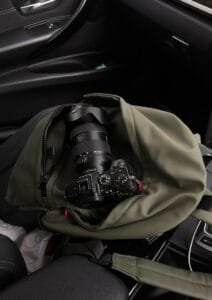 A camera bag sitting on the seat of a car