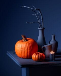A table topped with vases filled with pumpkins