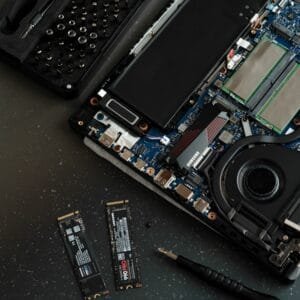A broken laptop computer sitting on top of a table