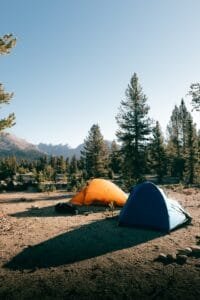 A couple of tents sitting on top of a dirt field