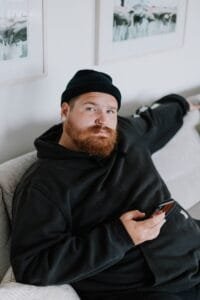 A man with a beard sitting on a couch
